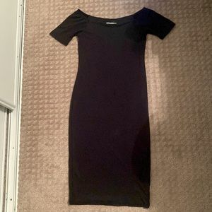 Knee length, tightly fitted black dress.